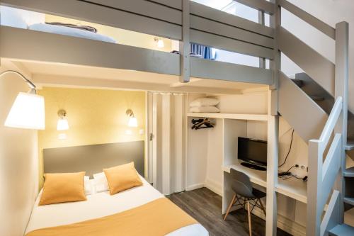 a bedroom with a bunk bed and a desk in a room at Au Patio Morand in Lyon