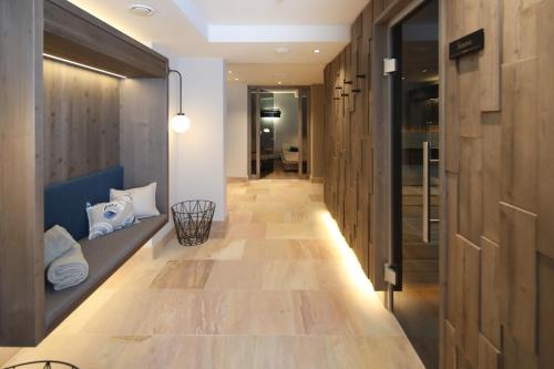a hallway with wooden walls and a long hallway with wooden floors at Landhaus Severin's Morsum Kliff in Morsum