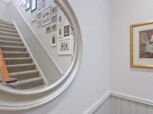 a spiral staircase in a museum with a picture on the wall at W12 Rooms in London
