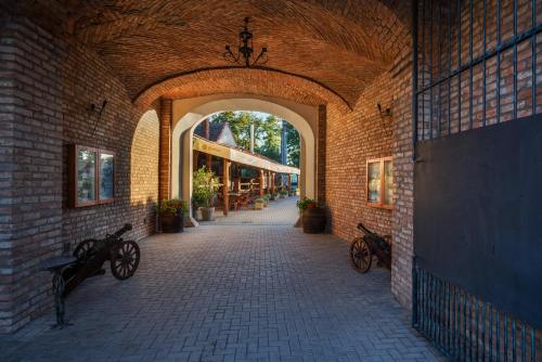 a brick hallway with bikes parked in a building at Chateau Krakovany in Krakovany