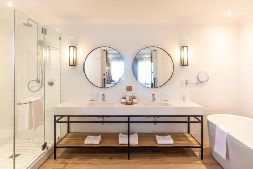 a bathroom with a sink and two mirrors at Shamwari Riverdene in Paterson