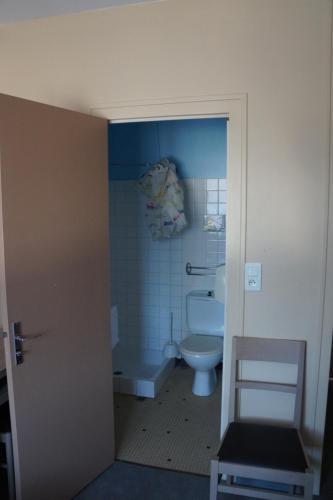 a bathroom with a toilet and a tub and a sink at Hotel Pinede in Saint-Jean-de-Monts
