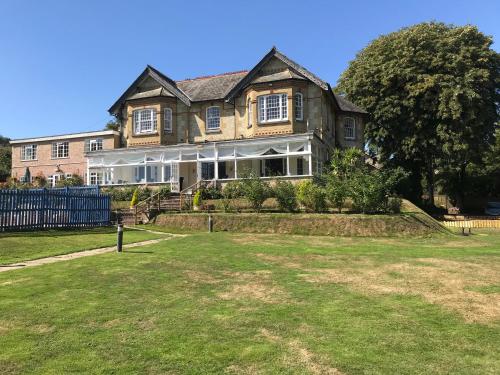 a large house with a yard in front of it at Luccombe Manor Country House Hotel in Shanklin