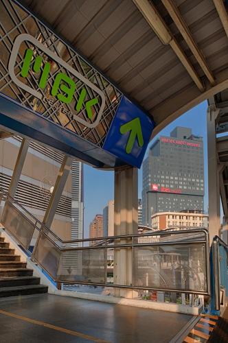 a sign for a subway station with a view of a city at Mercure Bangkok Siam in Bangkok