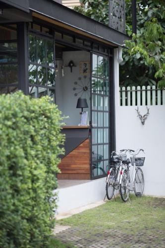 two bikes parked in front of a house at The Rodman Hotel in Chiang Mai