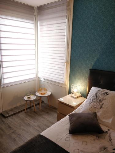 a bedroom with a bed and a window and a table at Les Clés du Bonheur by Beds4Wanderlust, 47m2 avec Terrasse privative & Parking-RER B TGV 10min-Orly 20min in Massy