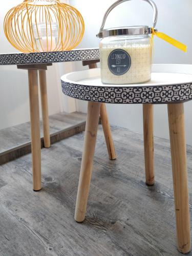 a table with a clock sitting on top of it at Les Clés du Bonheur by Beds4Wanderlust, 47m2 avec Terrasse privative & Parking-RER B TGV 10min-Orly 20min in Massy