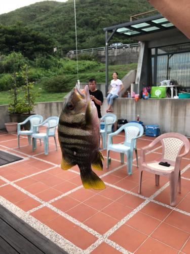 a fish hanging from a string with its mouth open at Beach Shoes Villa in Yanliau