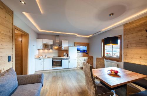 a kitchen and living room with a table and a couch at Haus Christophorus in Mariapfarr