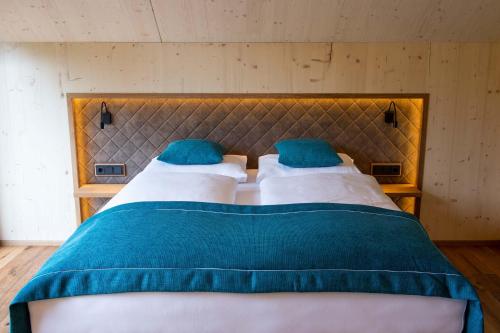 two beds with blue pillows in a bedroom at Haus Christophorus in Mariapfarr