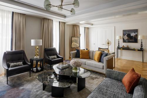 a living room with a couch and a table at Four Seasons Hotel London at Tower Bridge in London