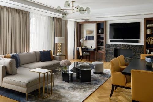 a living room with a couch and a table at Four Seasons Hotel London at Tower Bridge in London