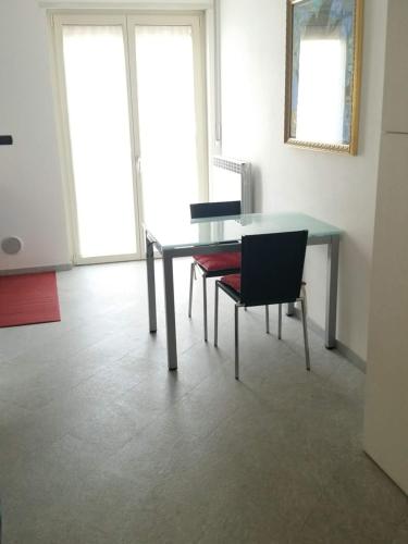 a dining room with a table and two chairs at Morbegno house in Morbegno