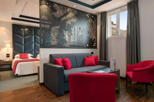 a hotel room with a couch and a bed at Hotel Nazionale in Rome