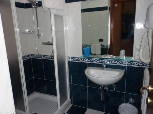 a bathroom with a sink and a shower at Hotel Cristall in San Benedetto del Tronto