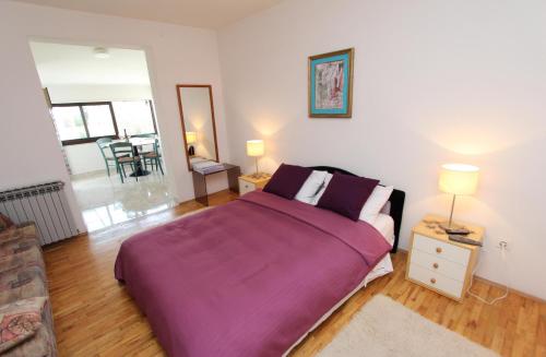 Ένα ή περισσότερα κρεβάτια σε δωμάτιο στο Apartments Milena