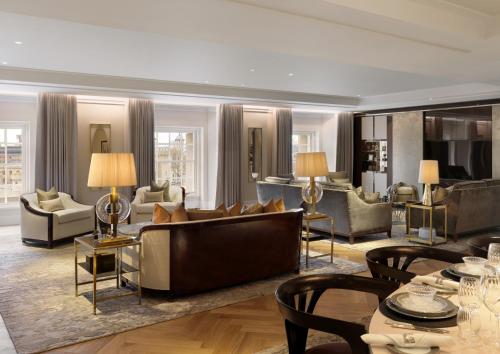 a living room with a couch and chairs at Four Seasons Hotel London at Tower Bridge in London