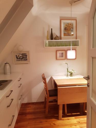 a kitchen with a wooden table and a dining room at Gästehaus Grogger in Weyer Markt