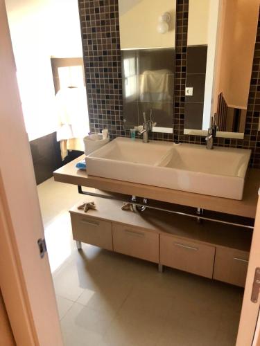 a bathroom with a large white sink and a mirror at Chalet en Espinosa Monteros in Espinosa de los Monteros
