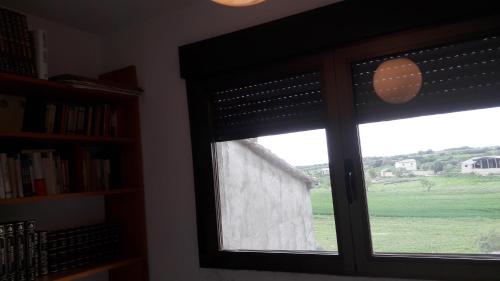 una ventana con vistas a un campo verde en Casa Sariñena, en Adahuesca