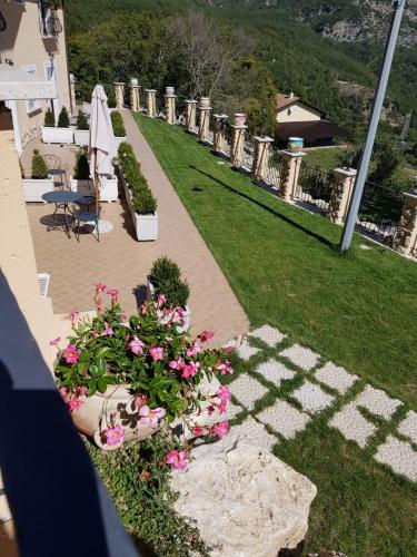 a garden with pink flowers and a pathway at Borgo Donna Teresa in Castel San Vincenzo