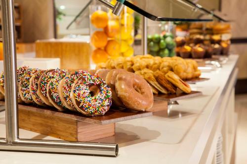 a counter with many different types of donuts on display at Wyndham Grand Orlando Resort Bonnet Creek in Orlando