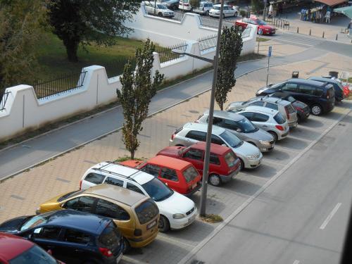 a row of cars parked in a parking lot at Dunavski Park in Novi Sad