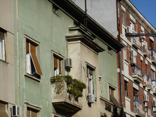 an old building with a balcony in a city at Dunavski Park in Novi Sad