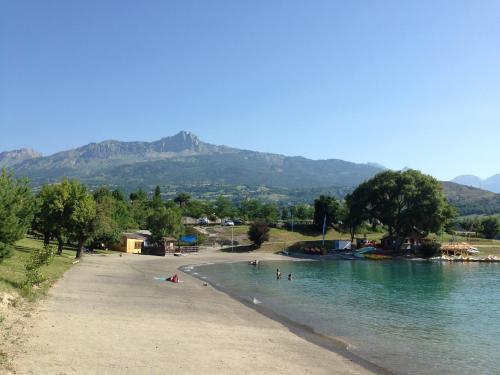 a group of people in the water on a beach at Gîte Chez Mary in Chorges