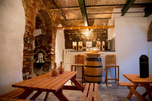 a room with a wooden table and a barrel at Penzion a vinařství NATURVINI in Miroslav