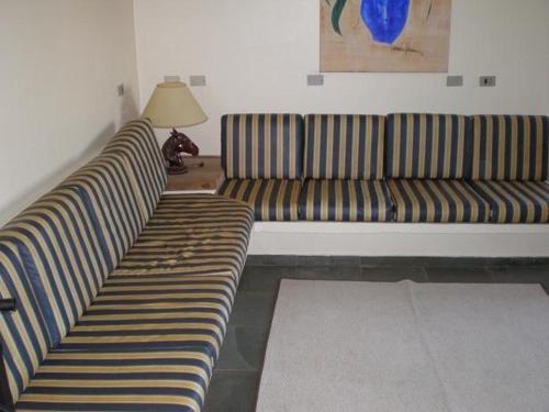 two striped couches in a living room with a lamp at Casa De Campo Boituva in Boituva