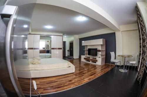 a bedroom with a bed and a table and chairs at Luxury Radox Apartment Airport Bucharest in Otopeni