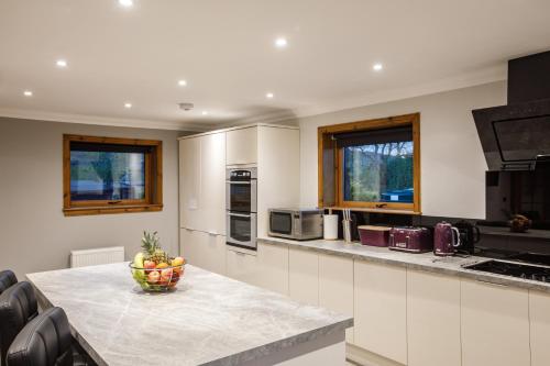 a kitchen with a bowl of fruit on a counter at North Balkello Cottage in Dundee
