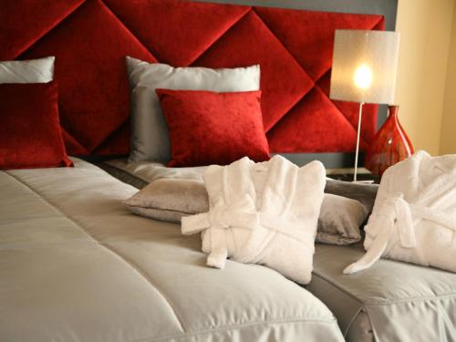 a bedroom with two beds with red pillows at Casa D' Joao Enes - Afife Residence in Afife