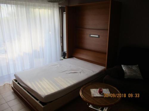 - un petit lit dans une chambre avec une table dans l'établissement RESIDENCE LES ECUREUILS, à Saint-Palais-sur-Mer