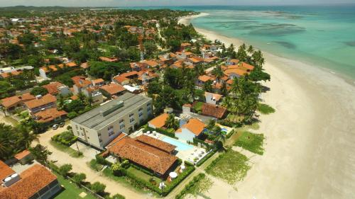 an aerial view of a resort on the beach at Pousada Baía Dos Corais in Tamandaré