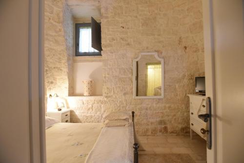 Ένα ή περισσότερα κρεβάτια σε δωμάτιο στο Trulli Occhi Di Pietra
