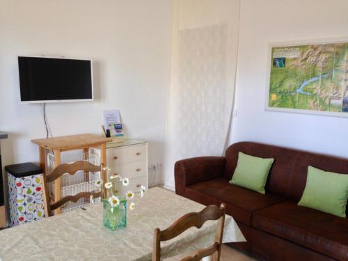 a living room with a couch and a table at Studio Chez Mary in Chorges