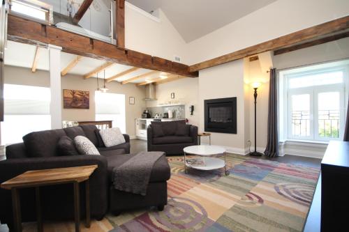 a living room with two couches and a tv at Kemptville Suites in Kemptville