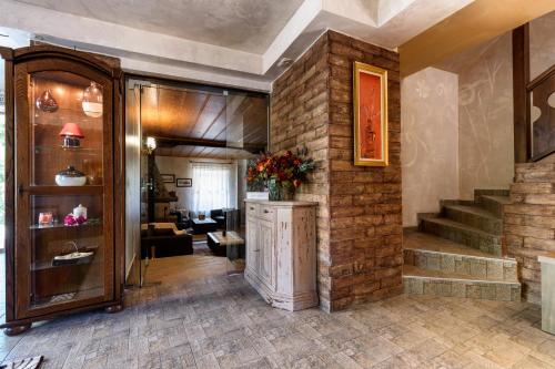 a lobby with a brick wall and a staircase at Velinov Boutique Hotel in Bansko