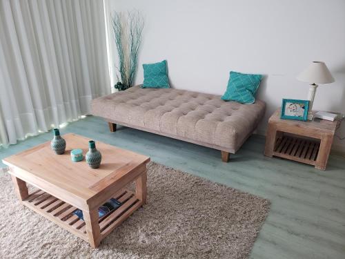 a living room with a couch and two tables at Edificio Paquebot, en Peninsula, con vista al mar in Punta del Este