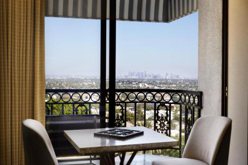 a balcony with a table and chairs and a view at The London West Hollywood at Beverly Hills in Los Angeles