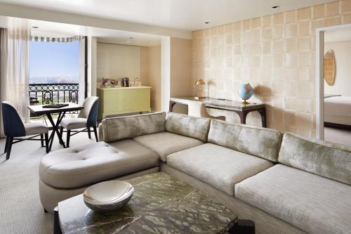 a living room with a couch and a table at The London West Hollywood at Beverly Hills in Los Angeles