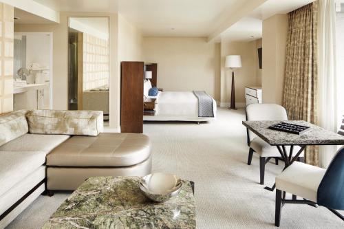 a living room with a couch and a bed at The London West Hollywood at Beverly Hills in Los Angeles