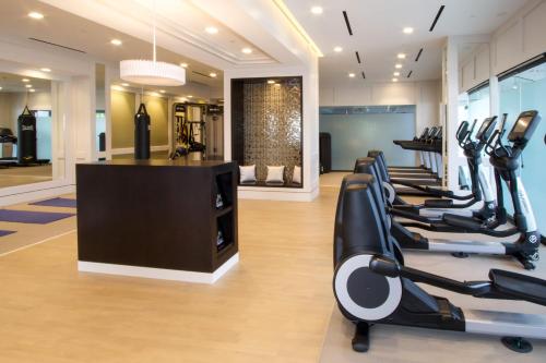 a gym with a row of treadmills and ellipticals at The London West Hollywood at Beverly Hills in Los Angeles