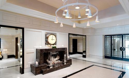 a living room with a fireplace and a clock on the wall at The London West Hollywood at Beverly Hills in Los Angeles