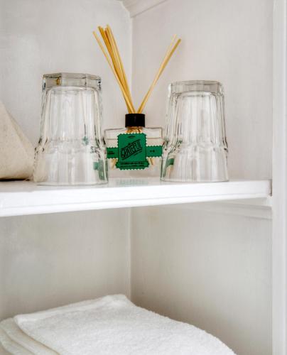 a shelf with two glass vases on it at The Water Street Inn in Kittery