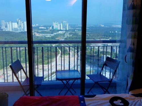 three chairs on a balcony with a view of the city at 1-4pax Mickey Mouse 1bedrm at Puteri Harbour, Teega Suite, Legoland, Lego, Iskandar in Nusajaya