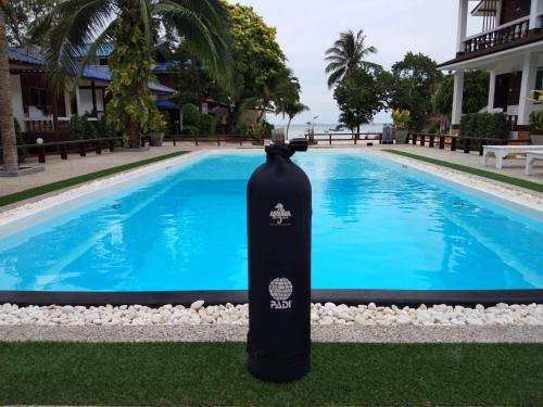 a water bottle sitting next to a swimming pool at Assava Dive Resort - SHA Plus in Koh Tao