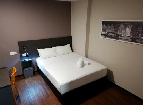 a bedroom with a bed with a teddy bear on it at The Loft Plaza Hotel in Bangi